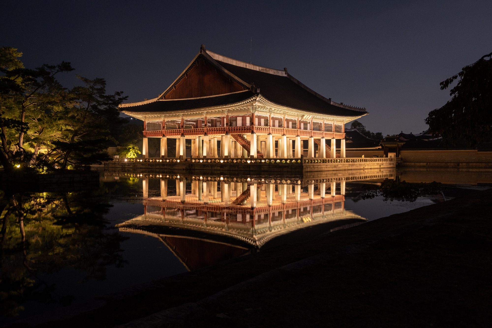Gyeonghoeru pavilion reflected in its pond during Gyeongbokgung's night opening