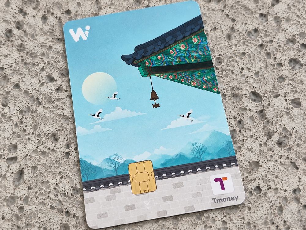 The Tmoney Travel Card Plus, illustrated with palace eaves, a wind bell and cranes over the mountains